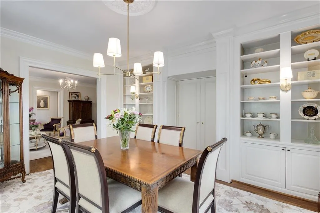 Thoughtful Dining Room closes off from the kitchen with doors and is loaded with built ins for storage