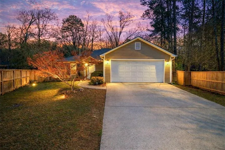 View of front facade with driveway and an attached garage