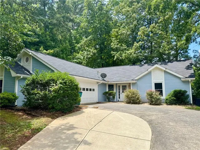 Ranch-style residence featuring light blue siding with white trim accents