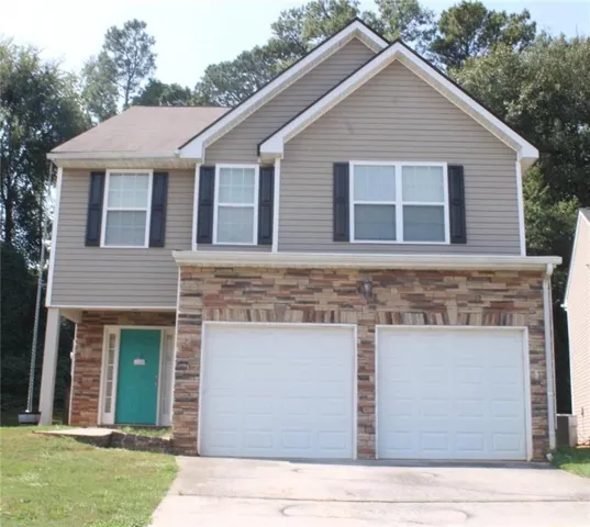 Two-story residence featuring a two car garage