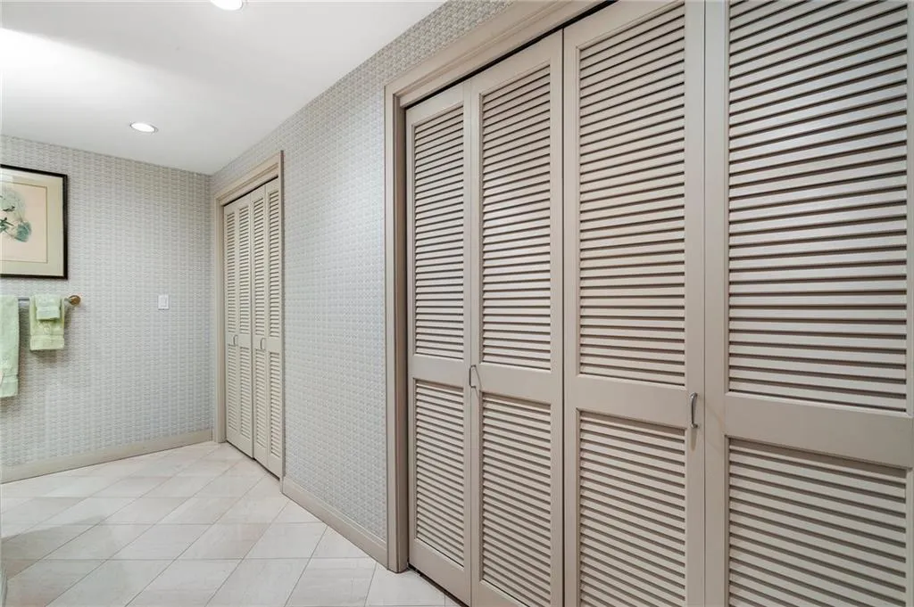 Hallway with recessed lighting, light tile patterned floors, baseboards, and wallpapered walls