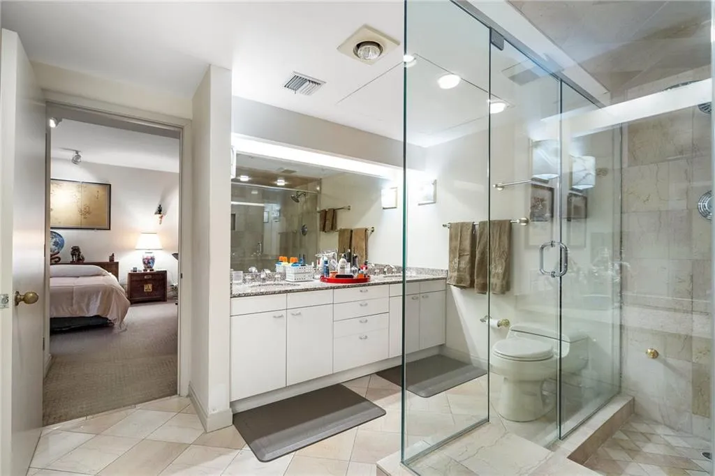 Full bathroom featuring tile patterned flooring, connected bathroom, vanity, visible vents, and a stall shower