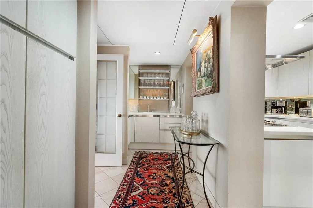 Hallway with light tile patterned floors and recessed lighting