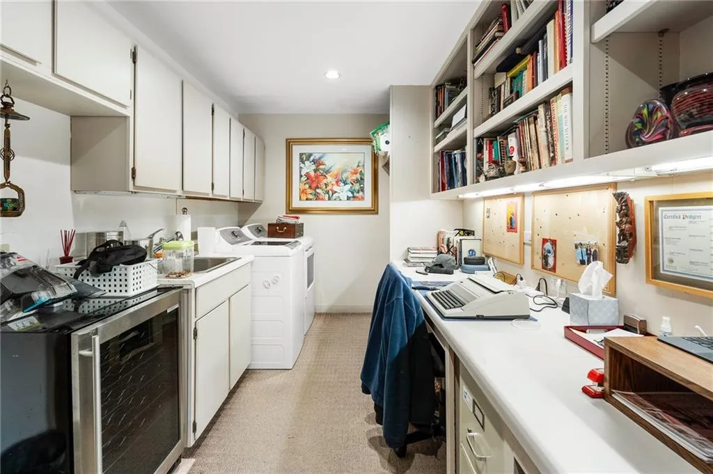 Clothes washing area with wine cooler, washer and clothes dryer, recessed lighting, a sink, and laundry area