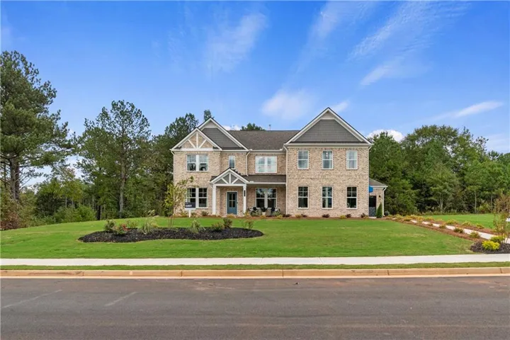 Two-story brick exterior with gabled roof lines and shingle detailing