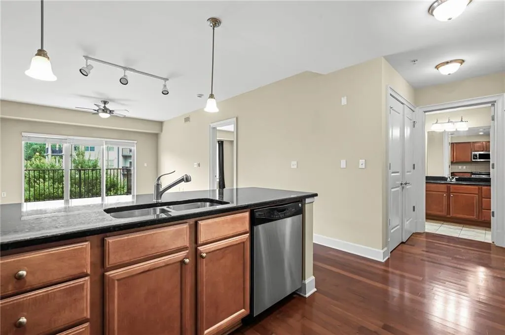 Kitchen island featuring a double-basin sink and stainless steel dishwasher