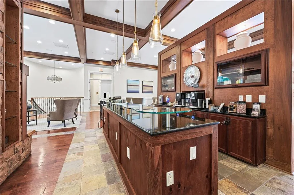 Spacious bar area with coffered ceiling located in community clubhouse