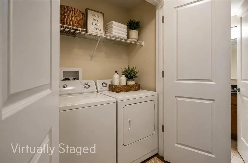Laundry area with ample storage, neutral tone walls