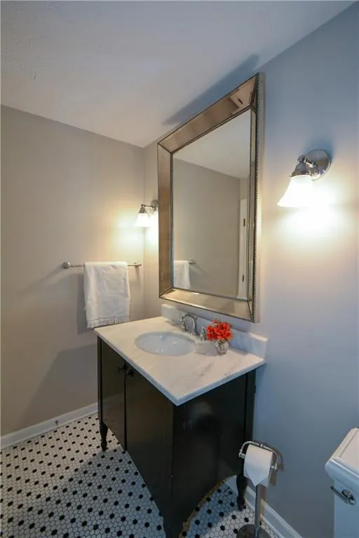 Bathroom with vanity and baseboards