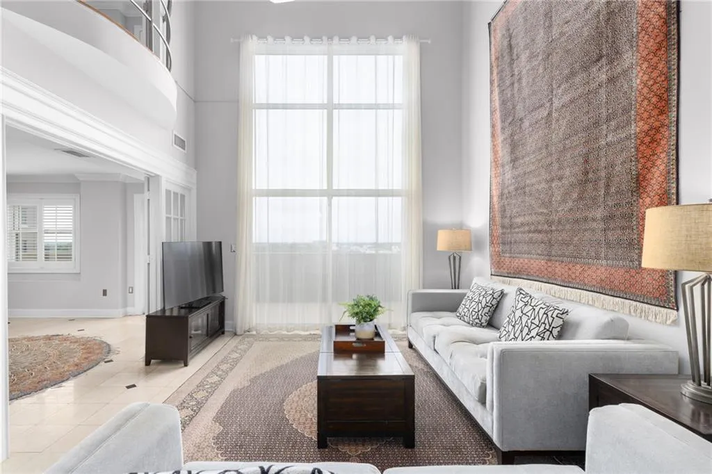 Two-story living area with a full-height window feature