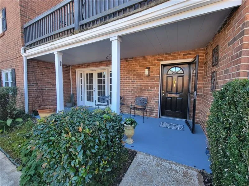 View of exterior entry with a porch