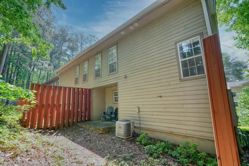 View of side of property with central AC unit