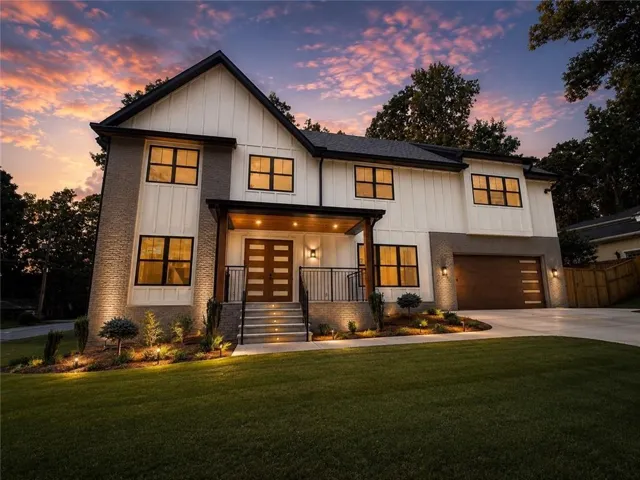 Contemporary residence featuring board and batten siding and brick accents