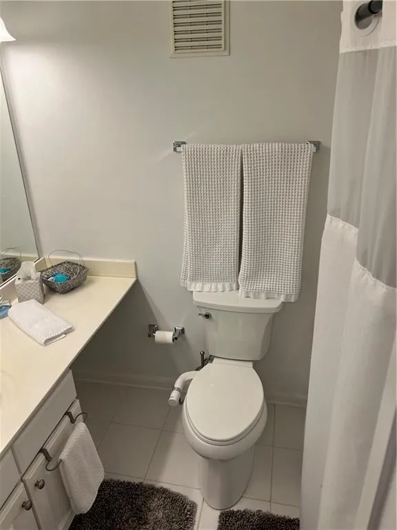 Full bathroom featuring tile patterned flooring, vanity, and a shower with shower curtain