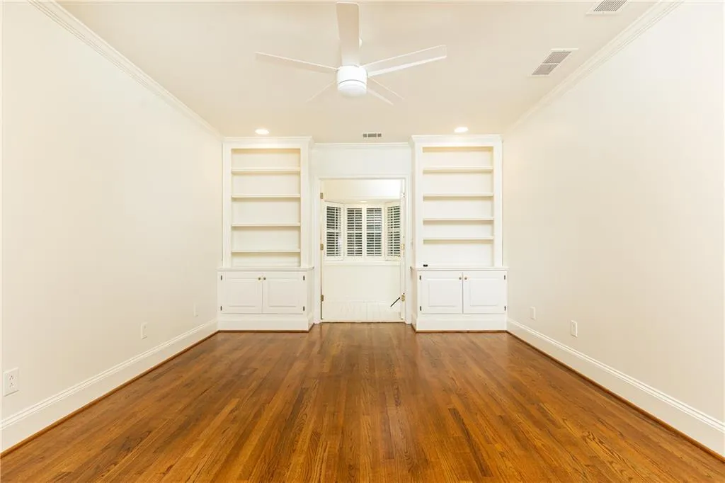 Built in cabinetry and bathroom with bay window and canopy views.