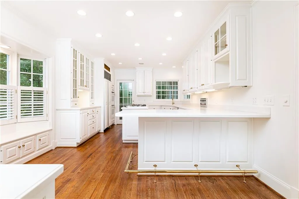 Large kitchen boasts bay windows and beautiful morning sunshine and opens up to a beautiful screened porch.