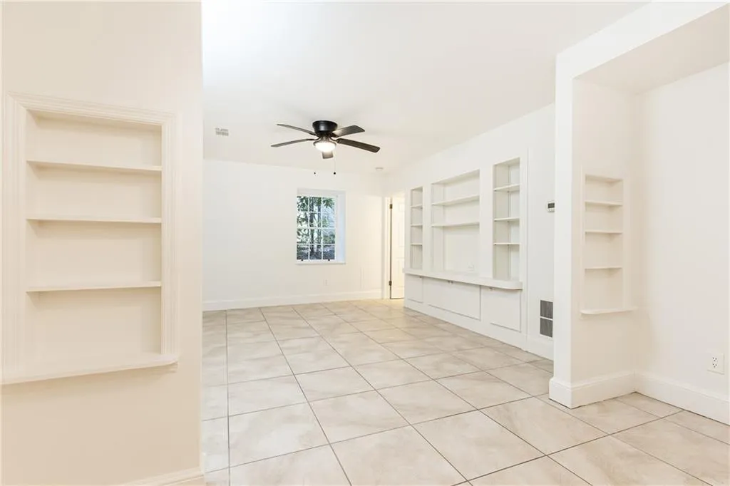 Generous au pair suite on the terrace level has living room, bedroom with walk-in closet, full bath, and kitchenette.
