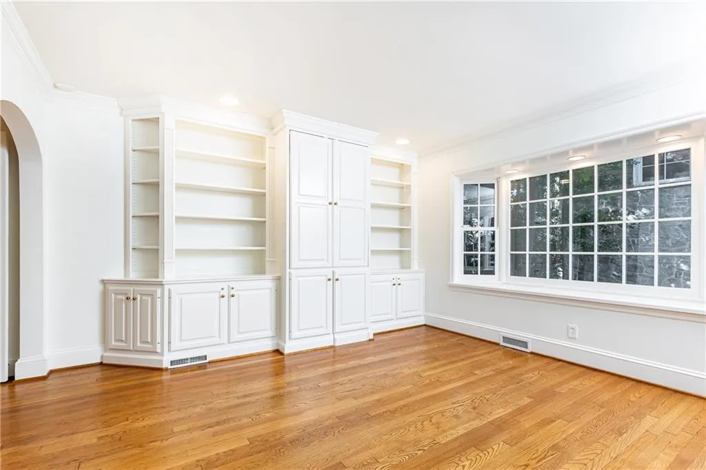 A wet bar is tucked neatly away in the handsome built in millwork.