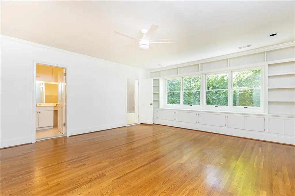 Window wall with built in cabinetry and canopy views.