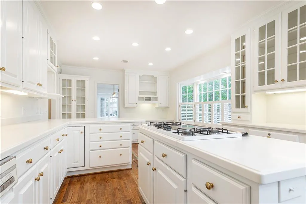 Lots of kitchen storage space and timeless glass china cabinets.