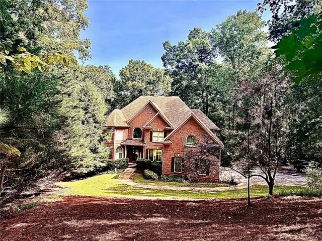 View of front of home featuring brick siding and a front yard
