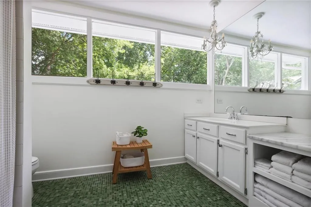 Full bath featuring vanity, a shower with curtain, and dark tile patterned floors