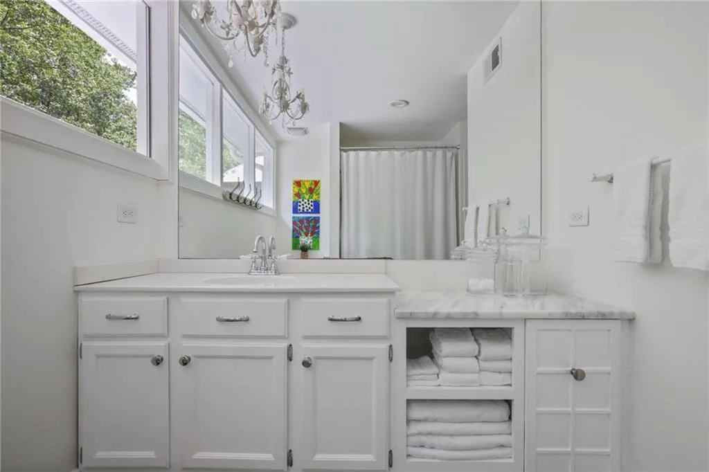 Bathroom with vanity and a shower with shower curtain