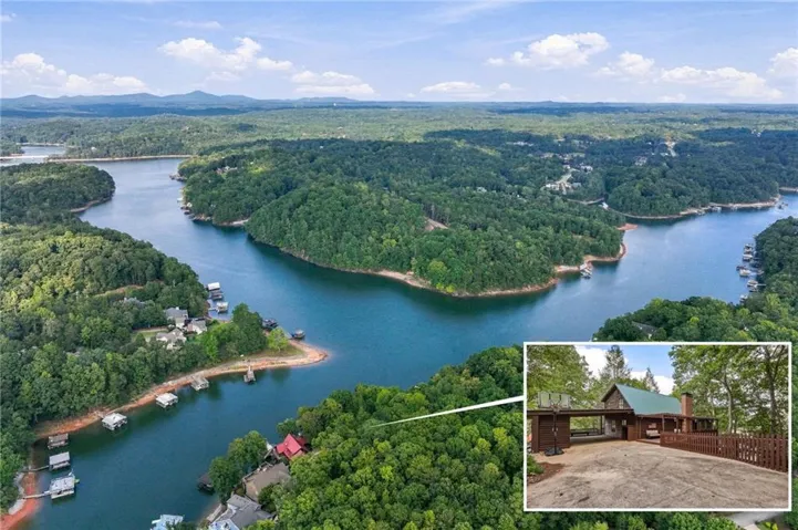 Expansive lakefront property featuring a wooded setting, private dock access, and a paved driveway
