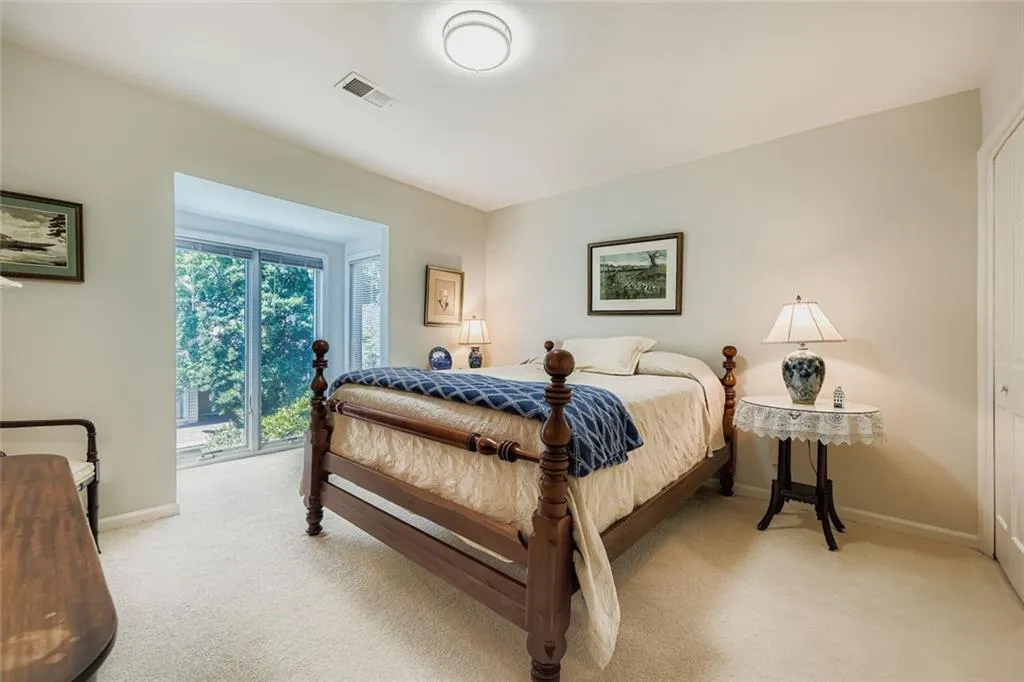 Bedroom featuring light colored carpet and a closet