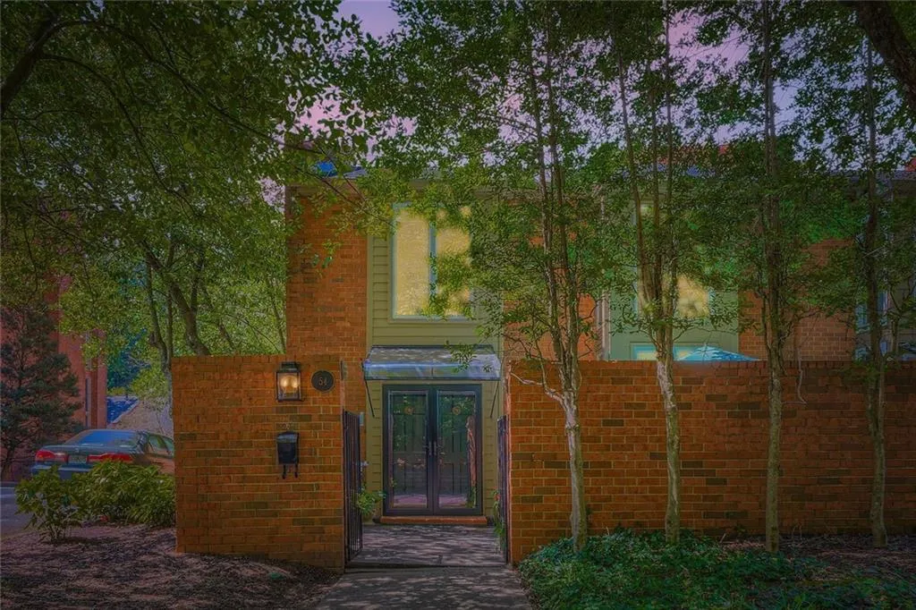 Doorway to property with brick siding and french doors
