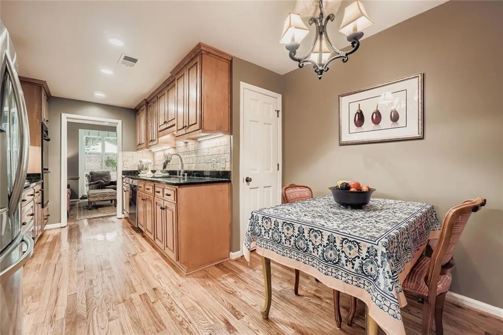 Dining area featuring light wood-style flooring, a chandelier, and recessed lighting