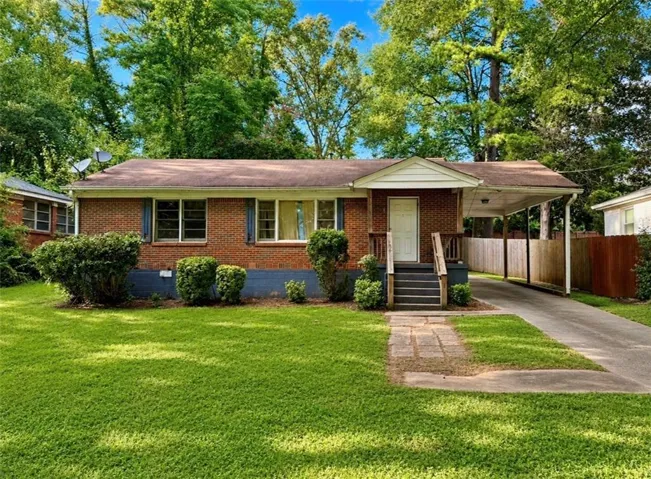 Charming brick ranch home featuring a welcoming front facade with covered entry portico, mature landscaping, and manicured lawn