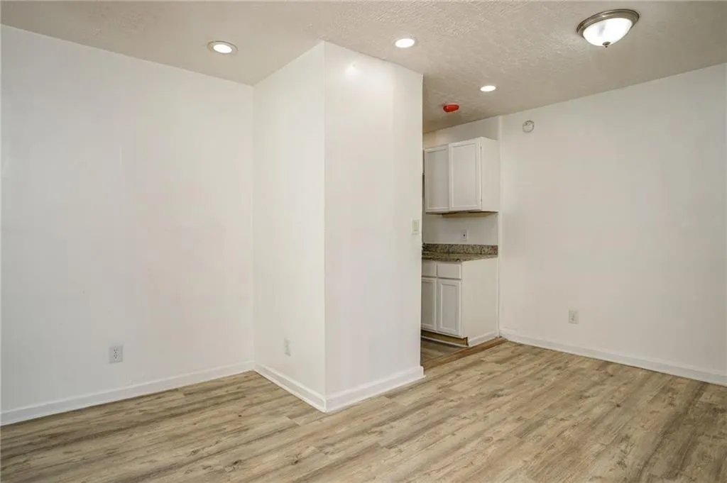 Unfurnished room featuring light wood-style floors, recessed lighting, and a textured ceiling