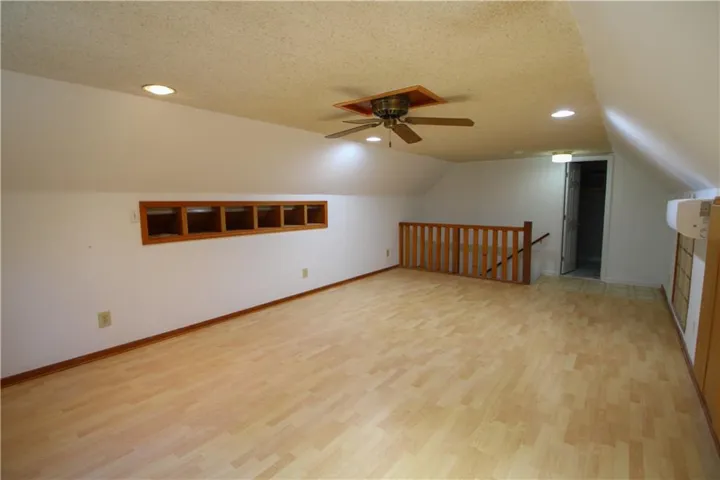 Bonus room with recessed lighting, a textured ceiling, a ceiling fan, light wood-style floors, and lofted ceiling