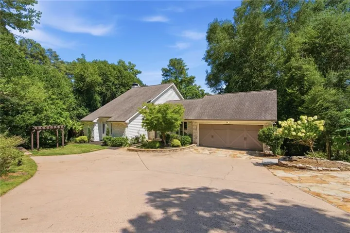 Spacious driveway with flagstone accents and integrated two-car garage