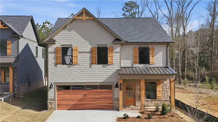 Craftsman-style exterior featuring shake siding and stone accents