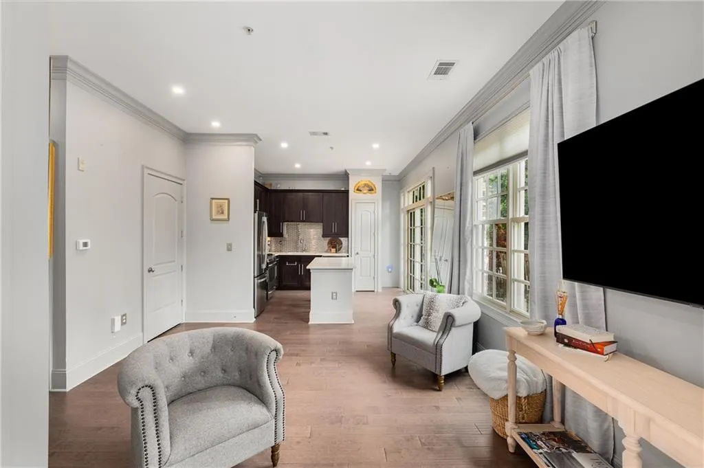Living area featuring ornamental molding, light wood finished floors, and recessed lighting