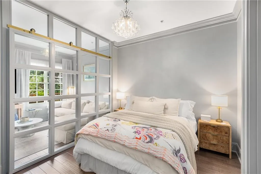 Bedroom featuring a chandelier, wood finished floors, and ornamental molding