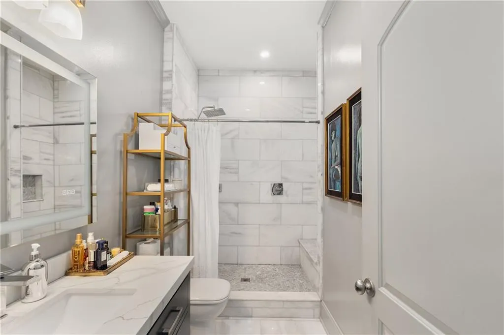 Bathroom with vanity, a tile shower, and recessed lighting