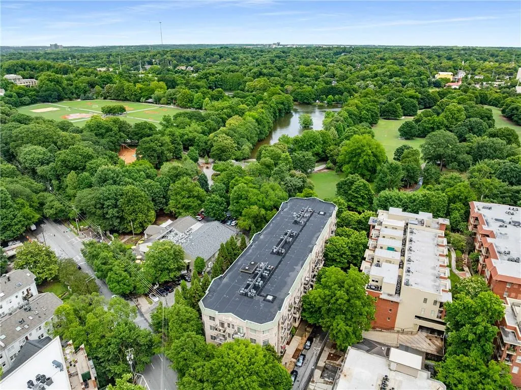 Aerial view of a nearby body of water and a tree filled landscape