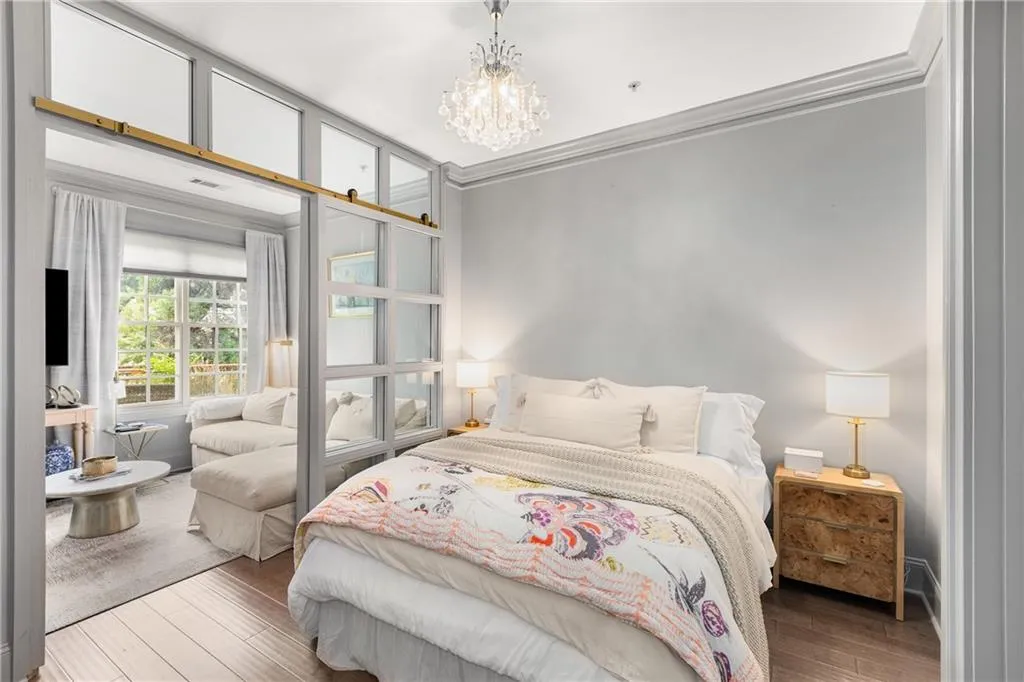 Bedroom featuring wood finished floors, a chandelier, and ornamental molding
