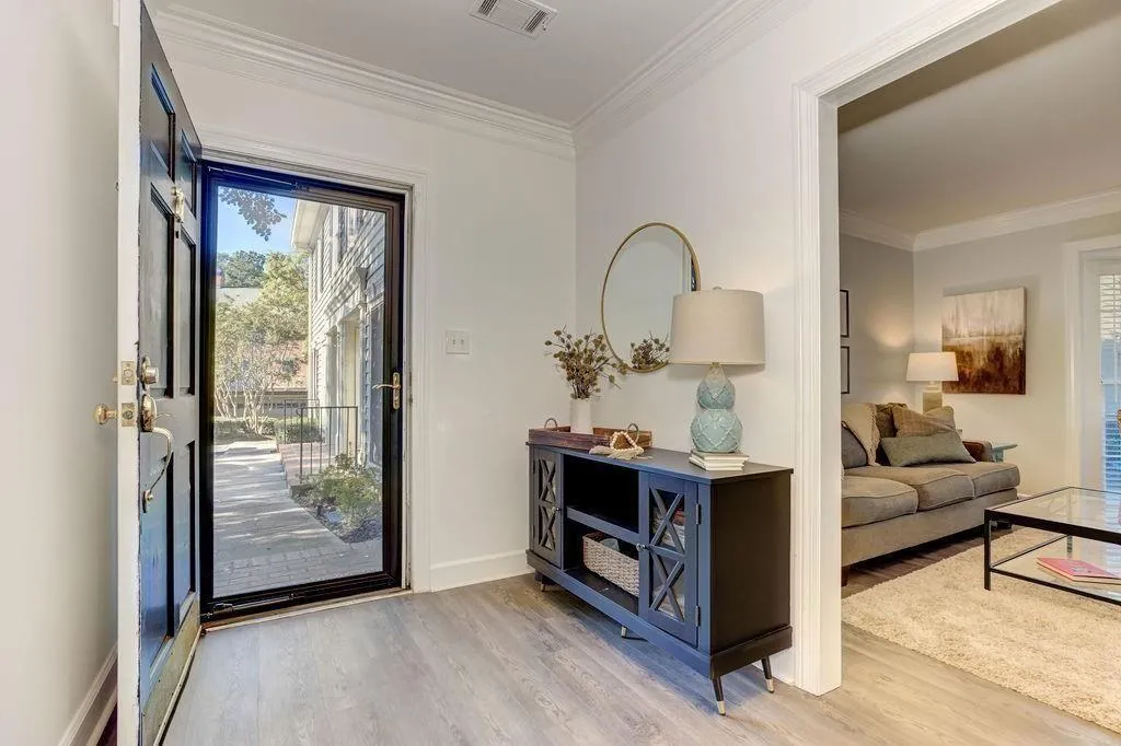 THIS GLASS DOOR ADDS ADDITIONAL LIGHTING TO THIS BEAUTIFUL FOYER..,.