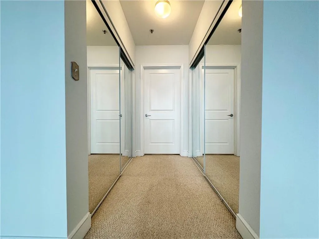 Hall with carpet floors and baseboards
