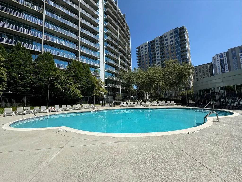 Community pool with a patio