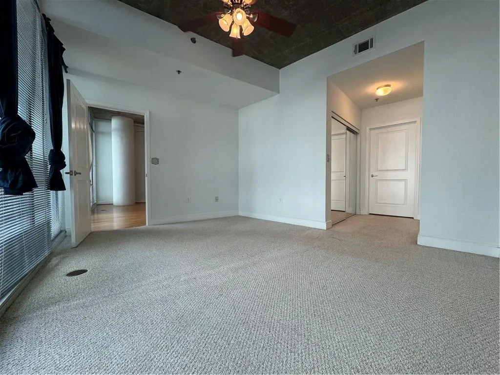 Unfurnished bedroom with a closet, carpet, and ceiling fan