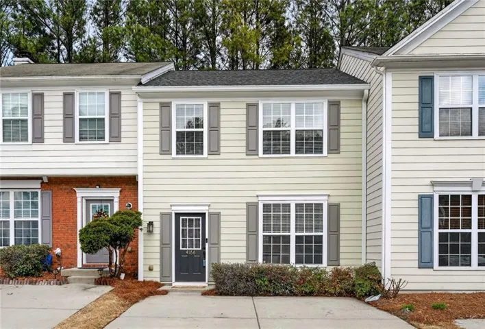 Colonial inspired home with brick siding