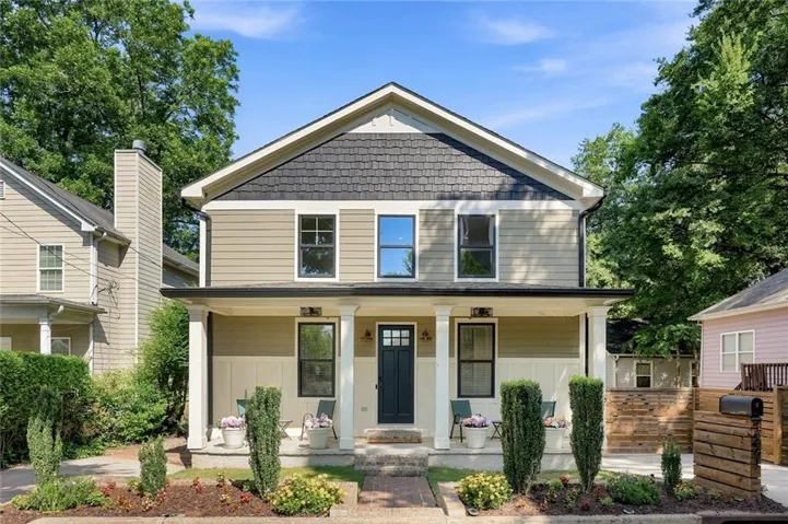 Craftsman-style facade with a covered front porch, horizontal siding, and decorative shingle accents