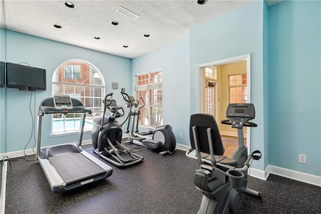 Exercise room featuring a wealth of natural light and a textured ceiling
