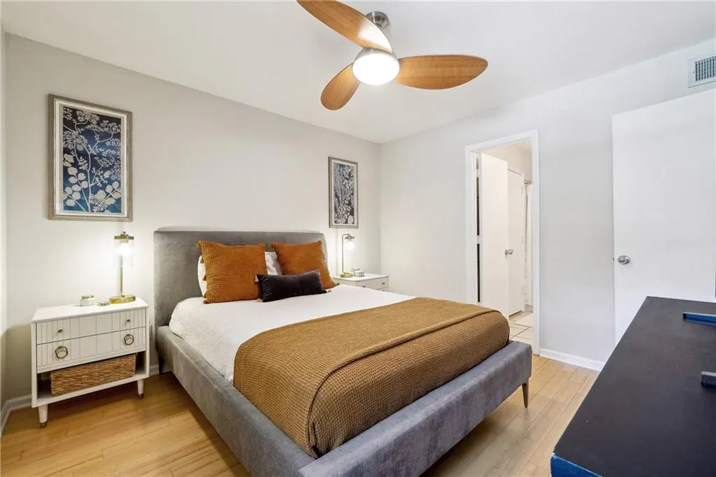 MasterBedroom featuring ensuite bathroom, ceiling fan, and hardwood / wood-style floors