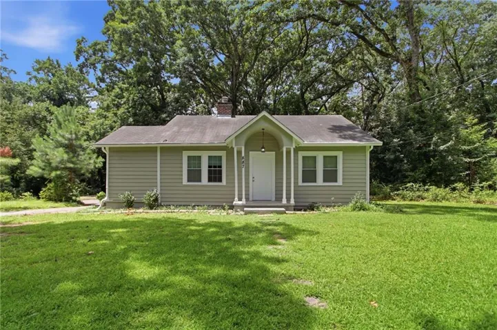 Single-story residence featuring light-colored siding and a covered front porch with white columns